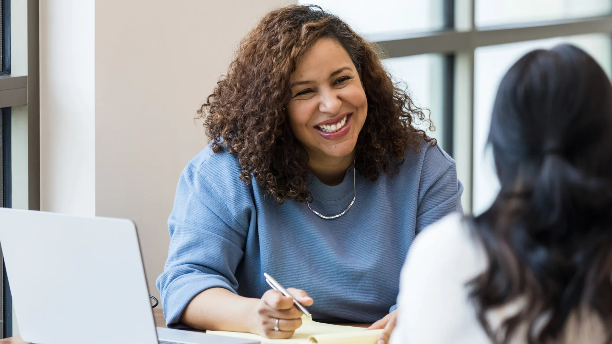 University lecturer engaging with students in a classroom representing effective teaching and performance management in higher education