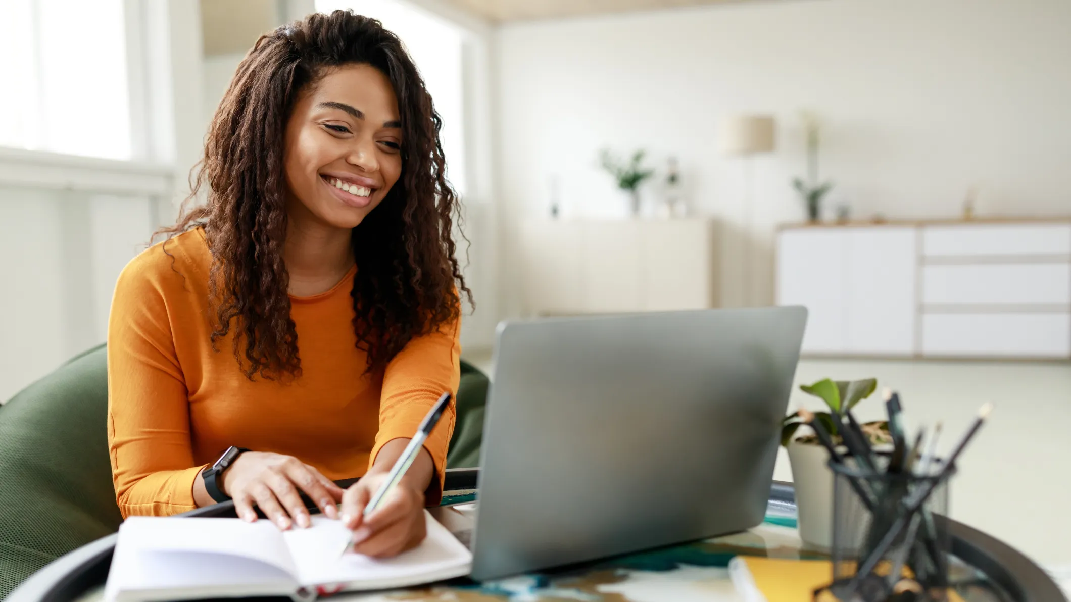 Smiling female student sitting at a desk working